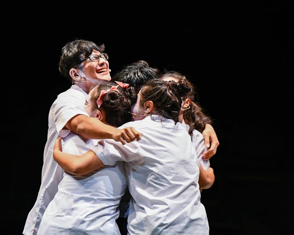 Danniel Iskandar hugging his Theatre For Young People batch mates as they complete the course